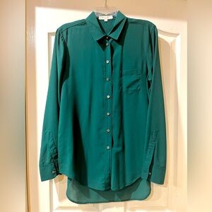 Women’s green light weight polyester long sleeve dressy button up blouse.